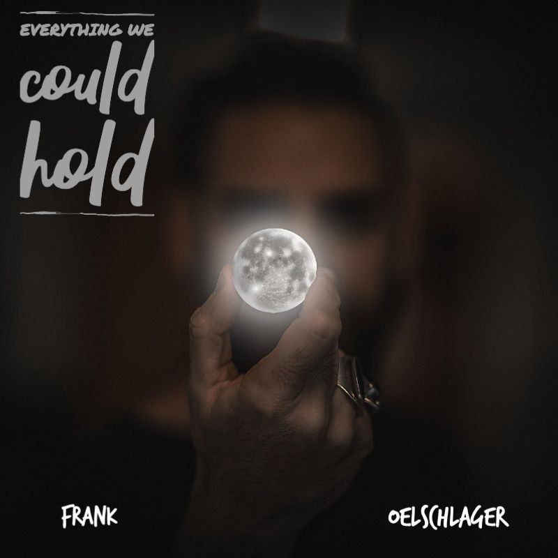 Everything We Could Hold cover art: a hand holding a small glowing moon in front of a blurred face